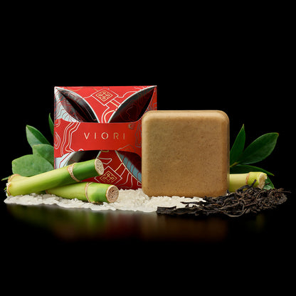 EPS bee hive with Viori conditioner bar, red packaging, sugarcane, rice grains, and tea leaves on black