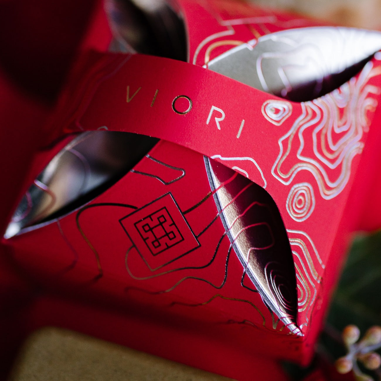 Red EPS bee hive with intricate gold and silver topographic design and cut-out details