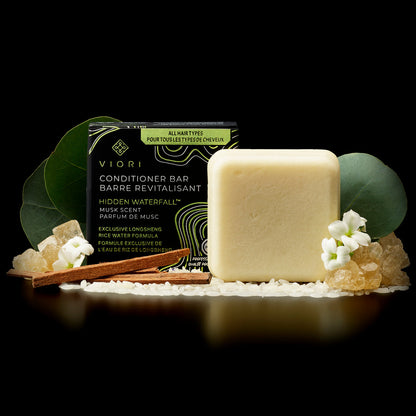 EPS bee hive shaped Viori Hidden Waterfall musk scent conditioner bar with packaging, cinnamon sticks, flowers, and crystals