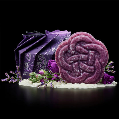 Purple EPS bee hive-shaped soap with floral packaging, surrounded by purple flowers and white beads