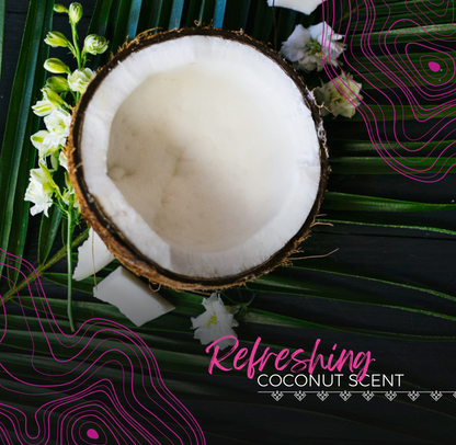 Half a coconut on green palm leaves with white flowers and text refreshing coconut scent