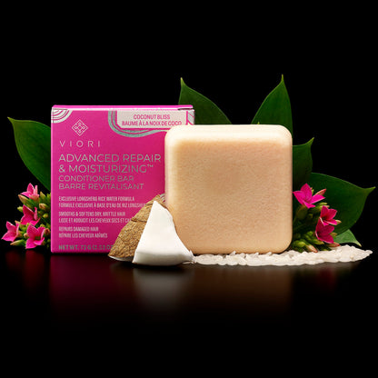 Viori Advanced Repair & Moisturizing conditioner bar with coconut slice, rice grains, and pink flowers on black background